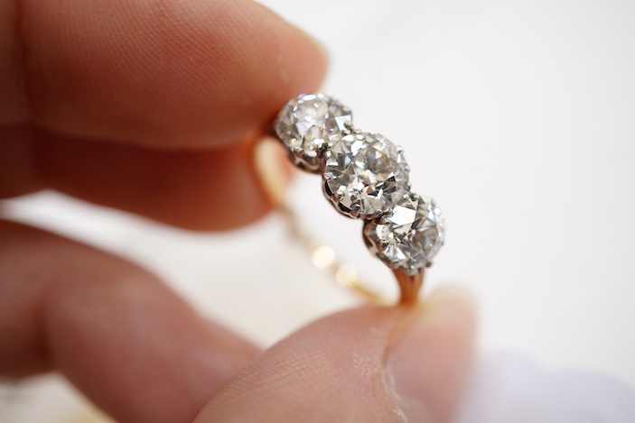 An attractive three-stone diamond ring, early 20th century